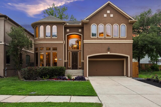 4436 Holt St, Bellaire, TX 77401 - mediterranean / spanish home with a garage, stucco siding, a front lawn, and concrete driveway