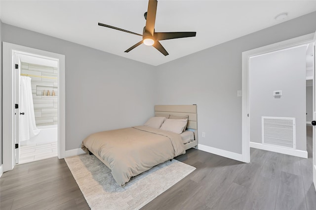 5122 Braesheather Dr, Houston, TX 77096 - bedroom featuring wood finished floors, baseboards, ceiling fan, and connected bathroom