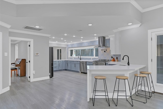5122 Braesheather Dr, Houston, TX 77096 - kitchen featuring dishwasher, wall chimney range hood, stove, a peninsula, and tasteful backsplash