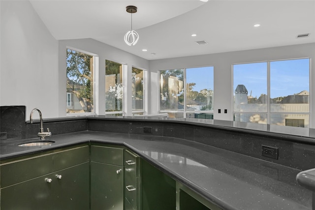 5122 Braesheather Dr, Houston, TX 77096 - kitchen with a sink, green cabinets, recessed lighting, dark countertops, and pendant lighting