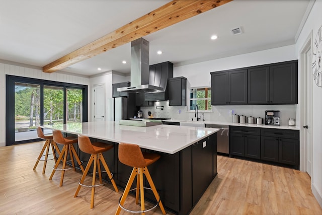 17131 Carrol Ln, Willis, TX 77378 - kitchen featuring stainless steel dishwasher, island range hood, beamed ceiling, light wood-style flooring, and backsplash