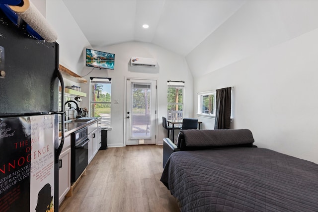 17131 Carrol Ln, Willis, TX 77378 - bedroom featuring freestanding refrigerator, access to exterior, light wood finished floors, a wall mounted air conditioner, and a sink