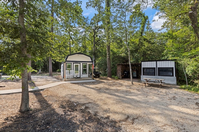 17131 Carrol Ln, Willis, TX 77378 - rear view of house with an outbuilding