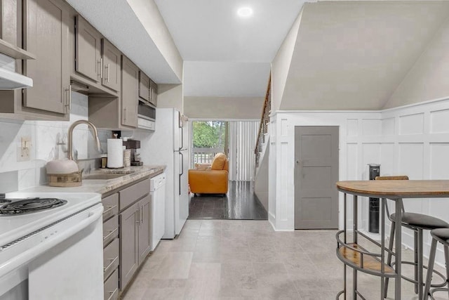 12900 Walden Rd Unit 302C, Montgomery, TX 77356 - kitchen with a sink, gray cabinets, decorative backsplash, light countertops, and dishwasher