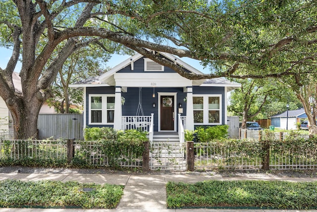 826 Omar St, Houston, TX 77009 - shotgun-style home with a porch and a fenced front yard