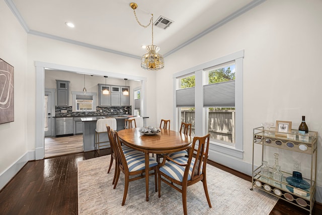 826 Omar St, Houston, TX 77009 - dining space featuring crown molding, hardwood / wood-style floors, a chandelier, and recessed lighting