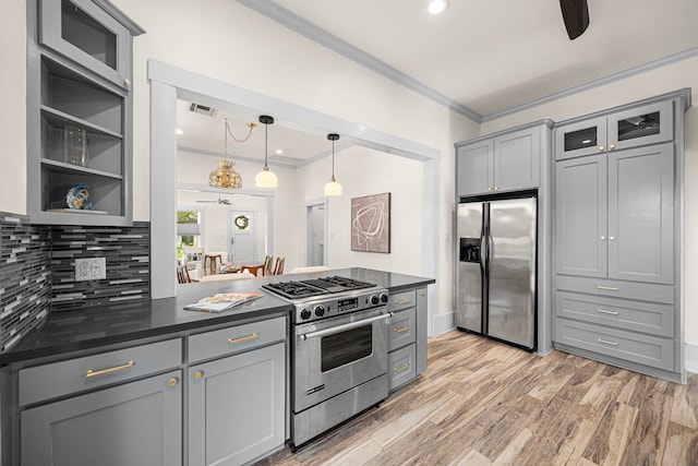 826 Omar St, Houston, TX 77009 - kitchen featuring stainless steel appliances, gray cabinetry, crown molding, dark countertops, and decorative backsplash