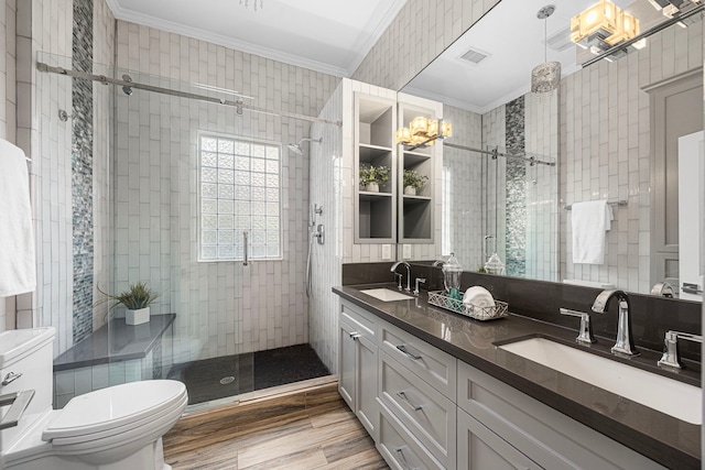 826 Omar St, Houston, TX 77009 - bathroom featuring crown molding, a stall shower, double vanity, and wood finished floors
