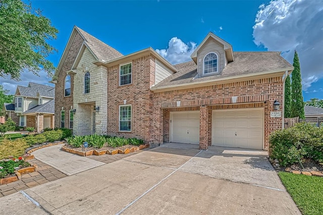 13311 Barbstone Dr, Houston, TX 77044 - traditional-style house with concrete driveway, brick siding, a garage, and roof with shingles