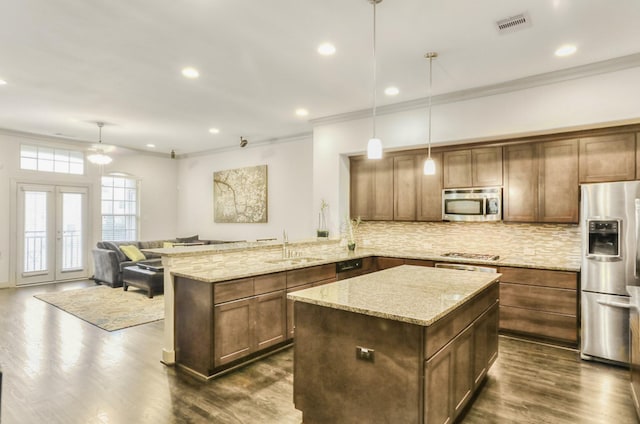 4247 Dickson St, Houston, TX 77007 - kitchen featuring stainless steel appliances, ornamental molding, a sink, backsplash, and a ceiling fan