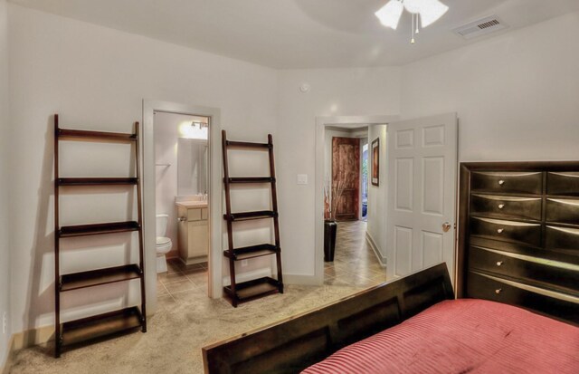 4247 Dickson St, Houston, TX 77007 - bedroom with light carpet, light tile patterned flooring, ensuite bathroom, and baseboards