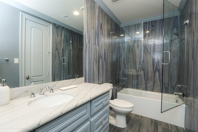 17122 Ashley Woods Ct, Spring, TX 77379 - full bath featuring vanity, toilet, wood finished floors, and bath / shower combo with glass door