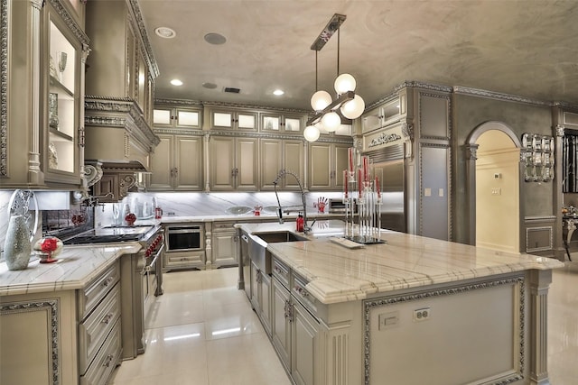 17122 Ashley Woods Ct, Spring, TX 77379 - kitchen with high end appliances, light tile patterned floors, decorative backsplash, a kitchen island with sink, and recessed lighting