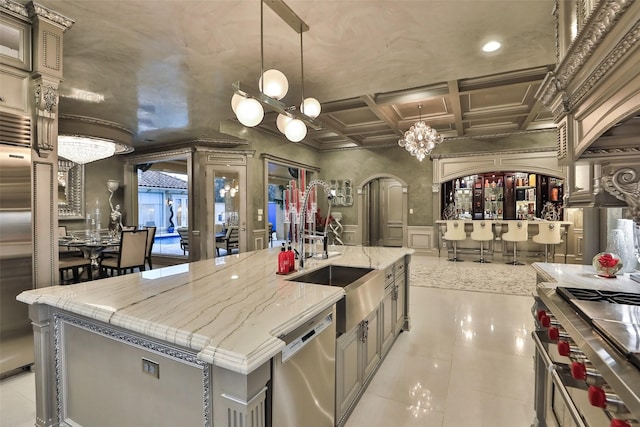 17122 Ashley Woods Ct, Spring, TX 77379 - kitchen featuring premium appliances, a chandelier, coffered ceiling, arched walkways, and recessed lighting