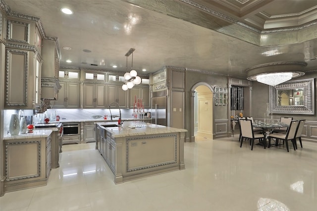 17122 Ashley Woods Ct, Spring, TX 77379 - kitchen with stainless steel built in fridge, arched walkways, an island with sink, tasteful backsplash, and light tile patterned floors
