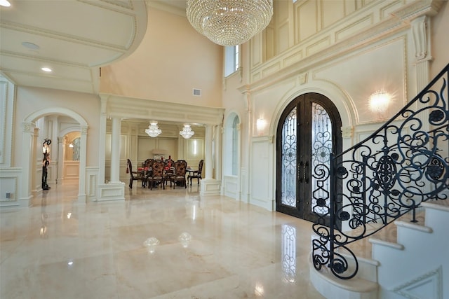17122 Ashley Woods Ct, Spring, TX 77379 - foyer with a decorative wall, arched walkways, a towering ceiling, ornate columns, and stairway