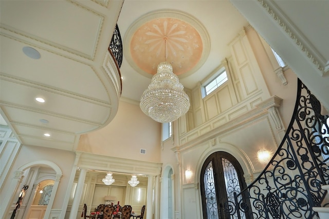 17122 Ashley Woods Ct, Spring, TX 77379 - detailed view of a chandelier, french doors, a decorative wall, recessed lighting, and arched walkways