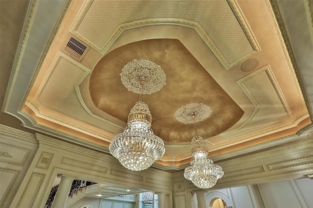 17122 Ashley Woods Ct, Spring, TX 77379 - detailed view of a chandelier, ornamental molding, and a tray ceiling