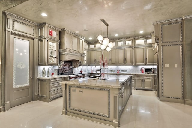 17122 Ashley Woods Ct, Spring, TX 77379 - kitchen with light tile patterned floors, tasteful backsplash, a kitchen island with sink, recessed lighting, and glass insert cabinets