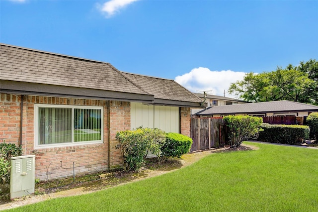 12028 Mighty Oak Dr Unit A, Houston, TX 77066 - view of side of property featuring brick siding and roof with shingles