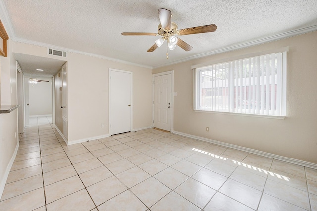 12028 Mighty Oak Dr Unit A, Houston, TX 77066 - unfurnished room with ceiling fan, a textured ceiling, ornamental molding, light tile patterned flooring, and baseboards