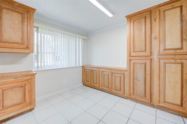 12028 Mighty Oak Dr Unit A, Houston, TX 77066 - unfurnished dining area featuring ornamental molding, a textured ceiling, and light tile patterned floors