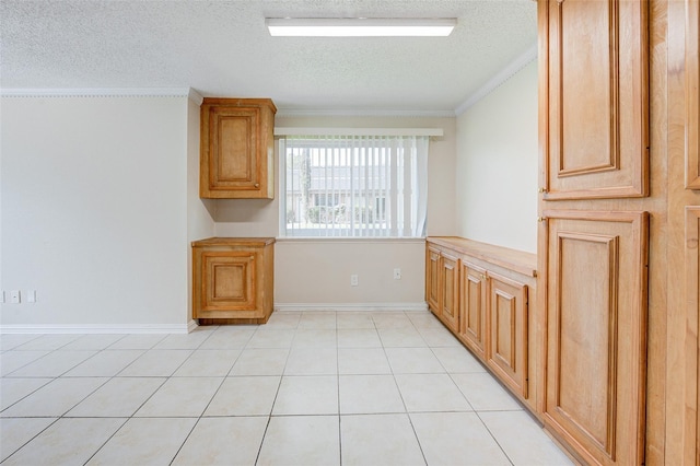 12028 Mighty Oak Dr Unit A, Houston, TX 77066 - unfurnished dining area featuring a textured ceiling, ornamental molding, baseboards, and light tile patterned floors