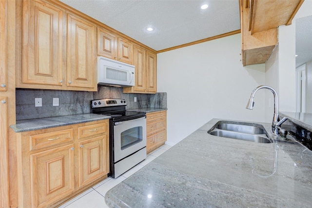 12028 Mighty Oak Dr Unit A, Houston, TX 77066 - kitchen with stainless steel range with electric cooktop, white microwave, a sink, light tile patterned floors, and backsplash