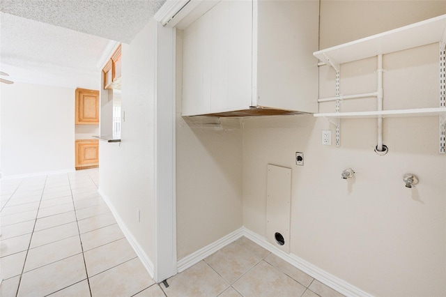 12028 Mighty Oak Dr Unit A, Houston, TX 77066 - washroom with light tile patterned floors, hookup for an electric dryer, gas dryer hookup, a textured ceiling, and baseboards