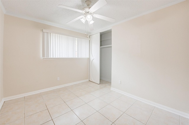 12028 Mighty Oak Dr Unit A, Houston, TX 77066 - unfurnished bedroom featuring a textured ceiling, a closet, ornamental molding, a ceiling fan, and baseboards