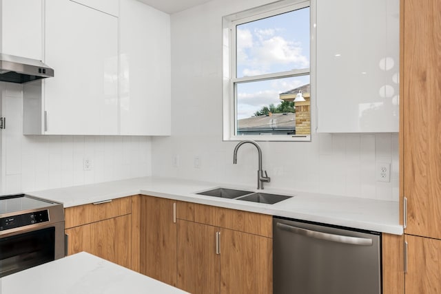 2312 Barbee St, Houston, TX 77004 - kitchen with stainless steel appliances, a sink, modern cabinets, wall chimney exhaust hood, and backsplash