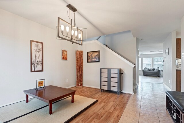 25430 Twister Trl, Spring, TX 77373 - living area featuring a chandelier, light wood-style flooring, baseboards, and stairs