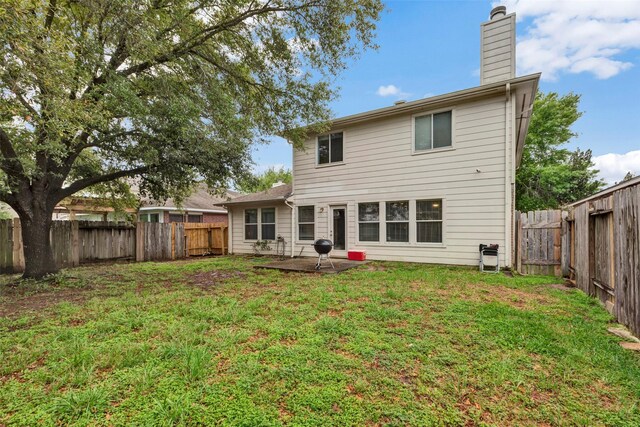 25430 Twister Trl, Spring, TX 77373 - rear view of property featuring a chimney and a patio