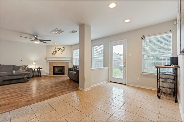 25430 Twister Trl, Spring, TX 77373 - living room with light tile patterned floors, a ceiling fan, a fireplace, baseboards, and recessed lighting