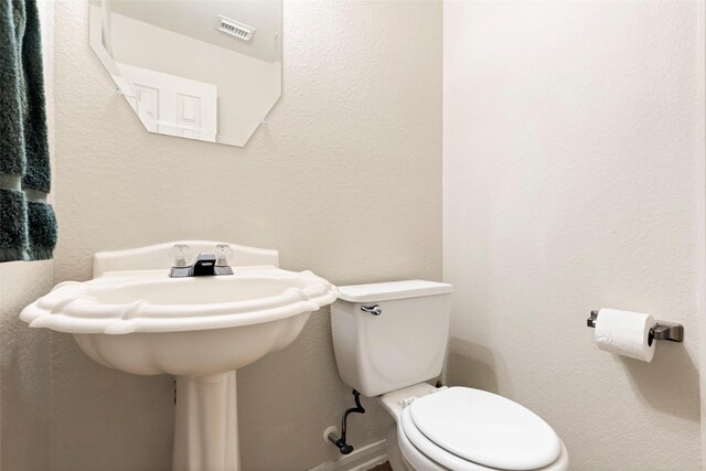 25430 Twister Trl, Spring, TX 77373 - half bathroom featuring toilet and a textured wall