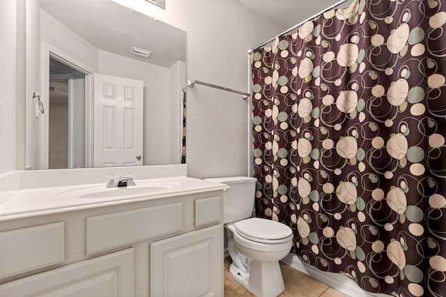 25430 Twister Trl, Spring, TX 77373 - full bath featuring toilet, vanity, tile patterned floors, a shower with curtain, and a textured wall