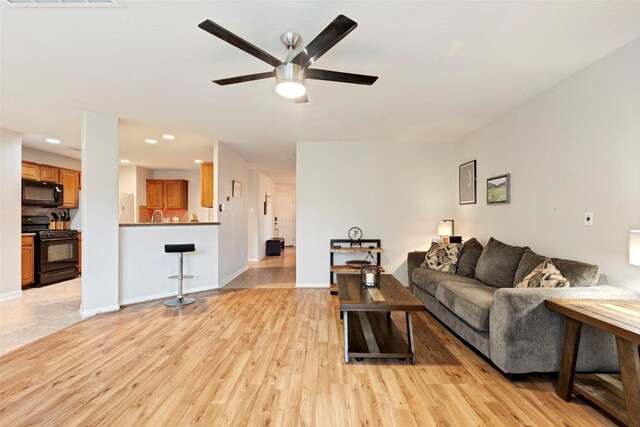 25430 Twister Trl, Spring, TX 77373 - living room featuring light wood-type flooring, a ceiling fan, recessed lighting, and baseboards