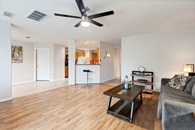 25430 Twister Trl, Spring, TX 77373 - living area featuring ceiling fan, light wood-type flooring, and baseboards