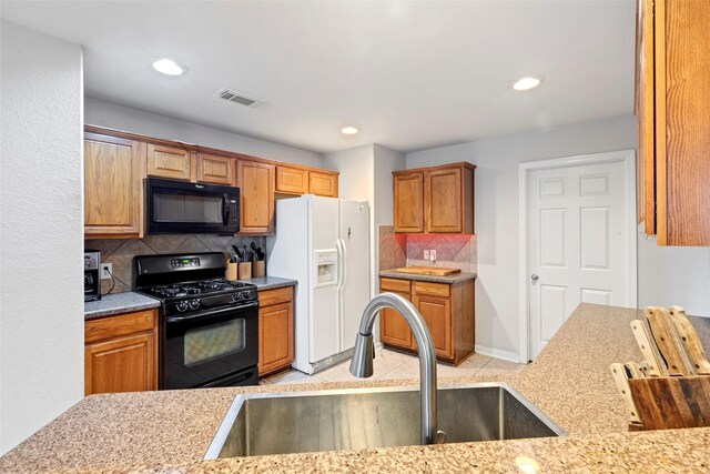 25430 Twister Trl, Spring, TX 77373 - kitchen with black appliances, a sink, backsplash, light tile patterned flooring, and recessed lighting