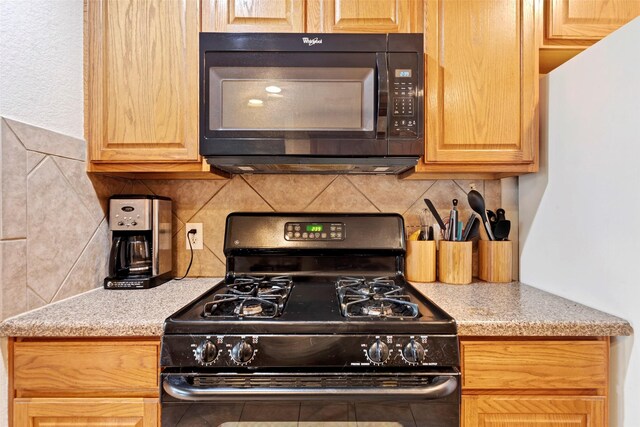 25430 Twister Trl, Spring, TX 77373 - kitchen with black microwave, gas stove, tasteful backsplash, and light brown cabinets