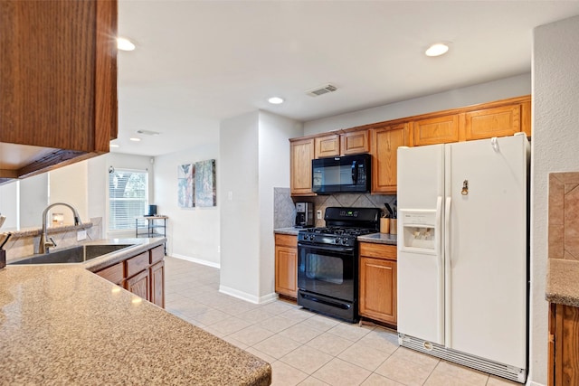 25430 Twister Trl, Spring, TX 77373 - kitchen featuring black appliances, a sink, decorative backsplash, light tile patterned flooring, and baseboards