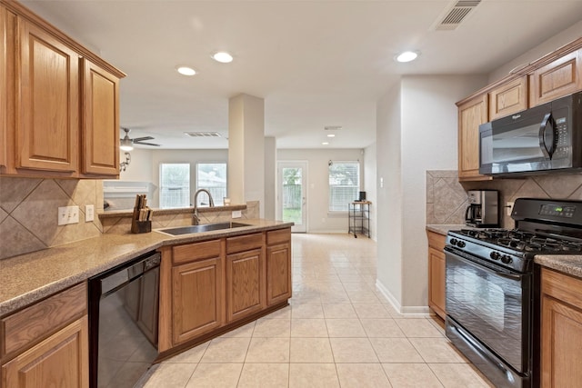 25430 Twister Trl, Spring, TX 77373 - kitchen with black appliances, a sink, tasteful backsplash, light tile patterned floors, and healthy amount of natural light