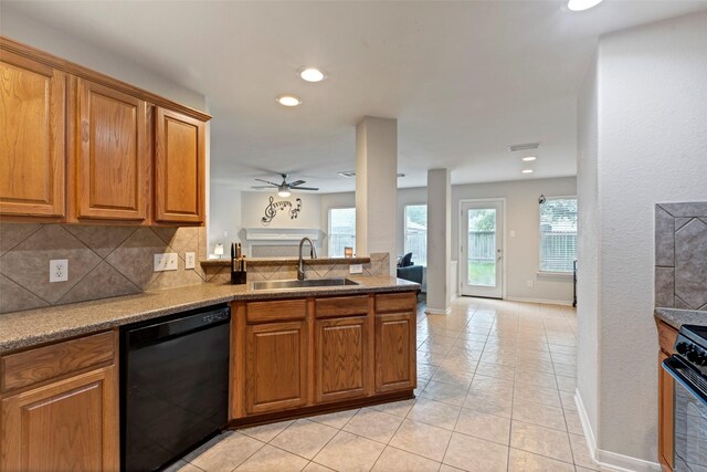 25430 Twister Trl, Spring, TX 77373 - kitchen with dishwasher, a sink, brown cabinets, range, and a ceiling fan