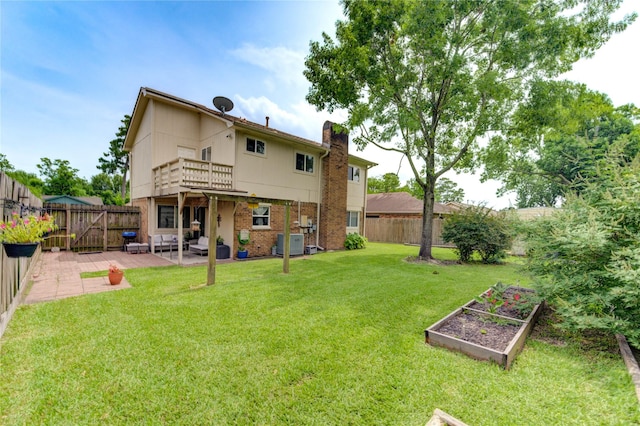 11111 Clear Fork Dr, Humble, TX 77396 - back of house with a garden, a patio, a chimney, central AC, and a balcony