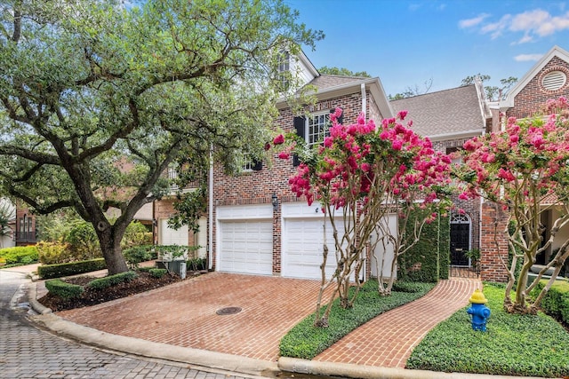 7 Pine Briar Cir, Houston, TX 77056 - traditional home with brick siding, decorative driveway, a shingled roof, and an attached garage