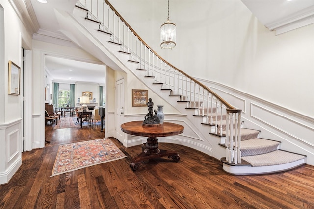 7 Pine Briar Cir, Houston, TX 77056 - entrance foyer featuring a decorative wall, stairway, wood finished floors, ornamental molding, and a wainscoted wall