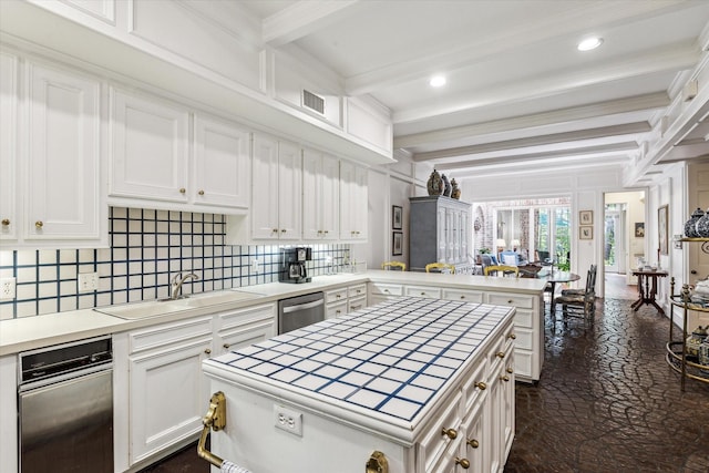 7 Pine Briar Cir, Houston, TX 77056 - kitchen with a sink, a peninsula, beamed ceiling, tile counters, and white cabinets