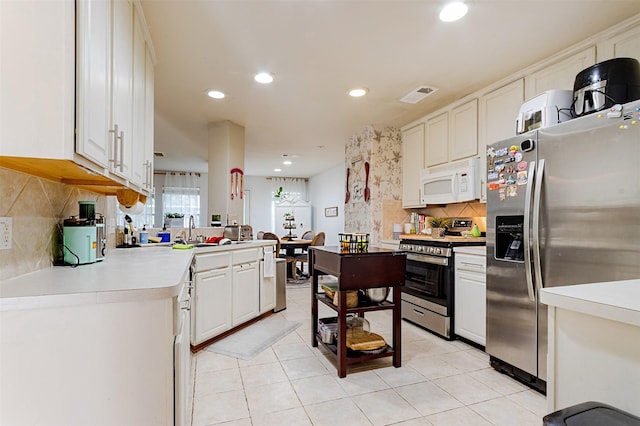 14639 Cypress Cottage Ct, Cypress, TX 77429 - kitchen with stainless steel appliances, light countertops, recessed lighting, backsplash, and a sink