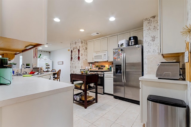 14639 Cypress Cottage Ct, Cypress, TX 77429 - kitchen featuring appliances with stainless steel finishes, light tile patterned floors, decorative backsplash, light countertops, and recessed lighting