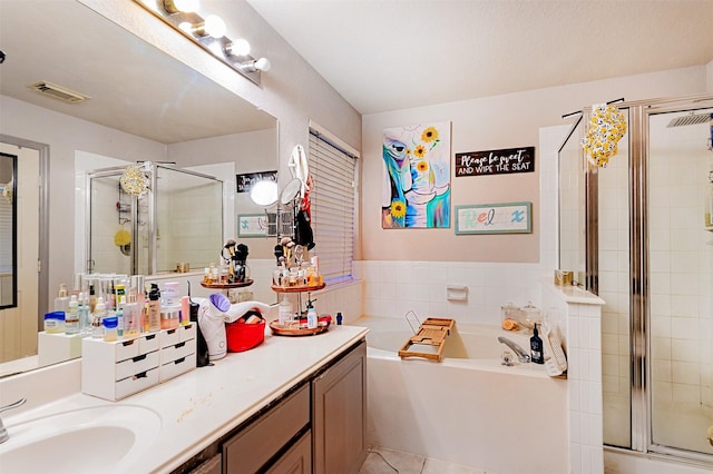 14639 Cypress Cottage Ct, Cypress, TX 77429 - bathroom with a stall shower, a garden tub, vanity, and tile patterned floors
